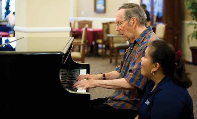 image of man playing piano in music therapy